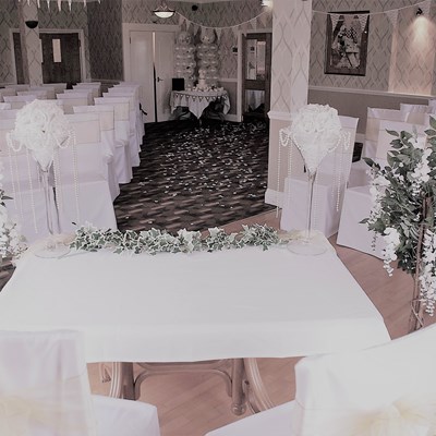 The room set up for a civil ceremony wedding taken looking from the head table