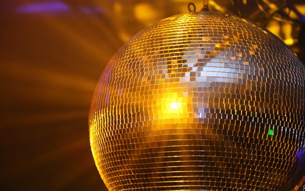 Mirror ball reflecting yellow light.