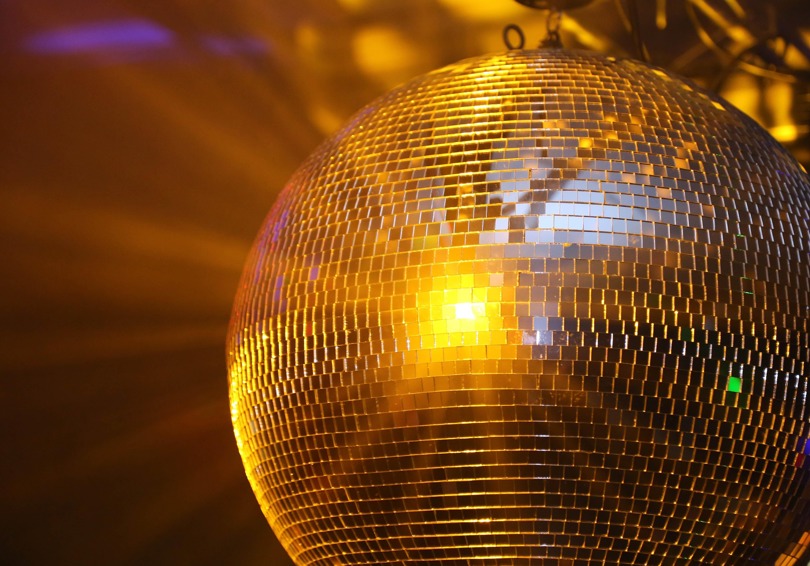 Mirror ball reflecting yellow light.