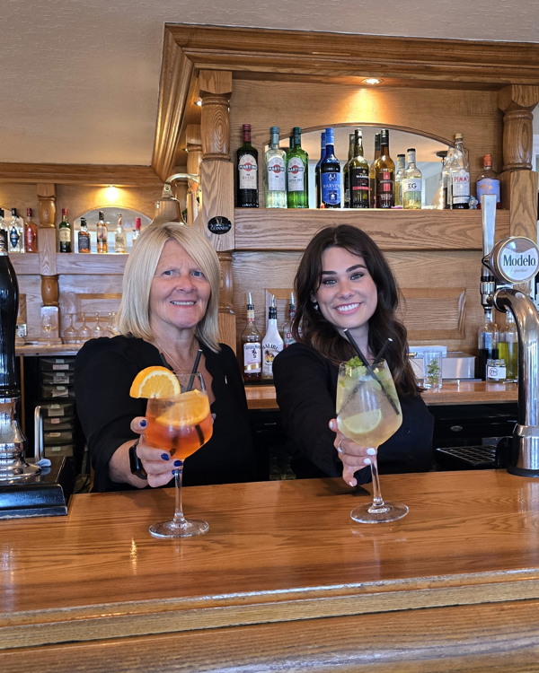 The Manor Events Manager Becky and Assistant Manager Starr serving drinks at the bar.