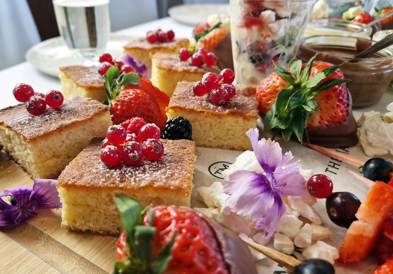 The Fruity One sharing board at The Manor Leeds; mini fruit tarts, berry skewers, lemon drizzle cake and Eton Mess.
