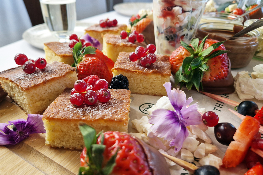 The Fruity One sharing board at The Manor Leeds; mini fruit tarts, berry skewers, lemon drizzle cake and Eton Mess.