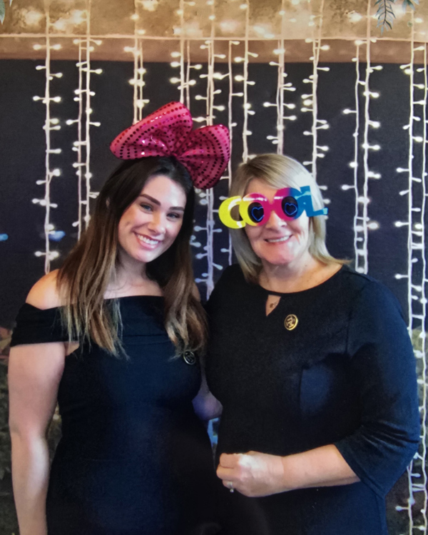 The Manor Events Manager Becky with Assistant Manager Starr wearing photobooth props.