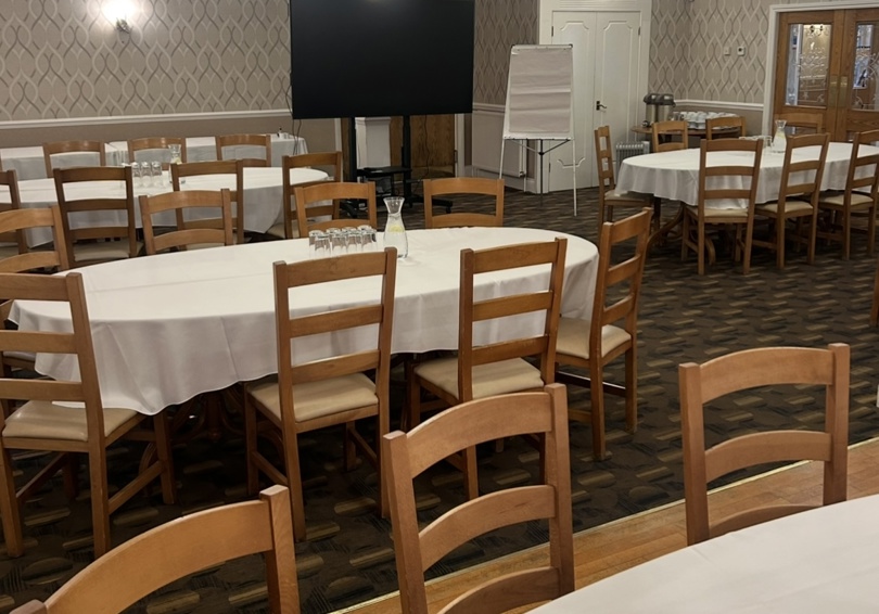 Tables in High Garden at The Manor Leeds set-up for a conference.
