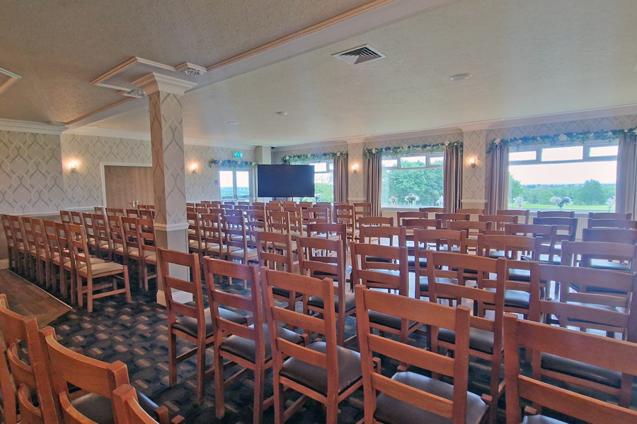 Rows of chairs set-up in High View at The Manor Leeds, with the 84" digital display the the front left.