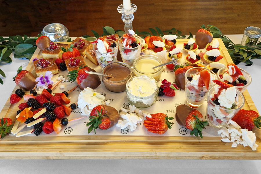 The Fruity One sharing board at The Manor Leeds; mini fruit tarts, berry skewers, lemon drizzle cake and Eton Mess.