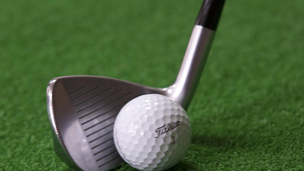 A Titlelist golf ball and club.