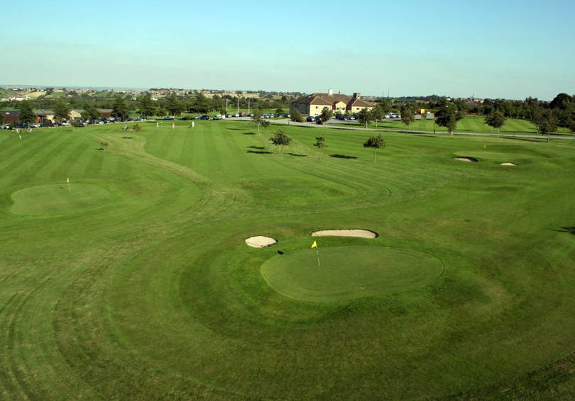 View of the Par 3 Academy Course at The Manor Leeds, with main building in the background.