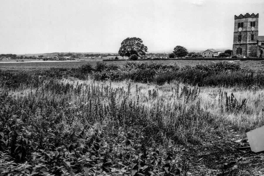 A photo showing the farmland with a view of St Paul’s Church, Drighlington.