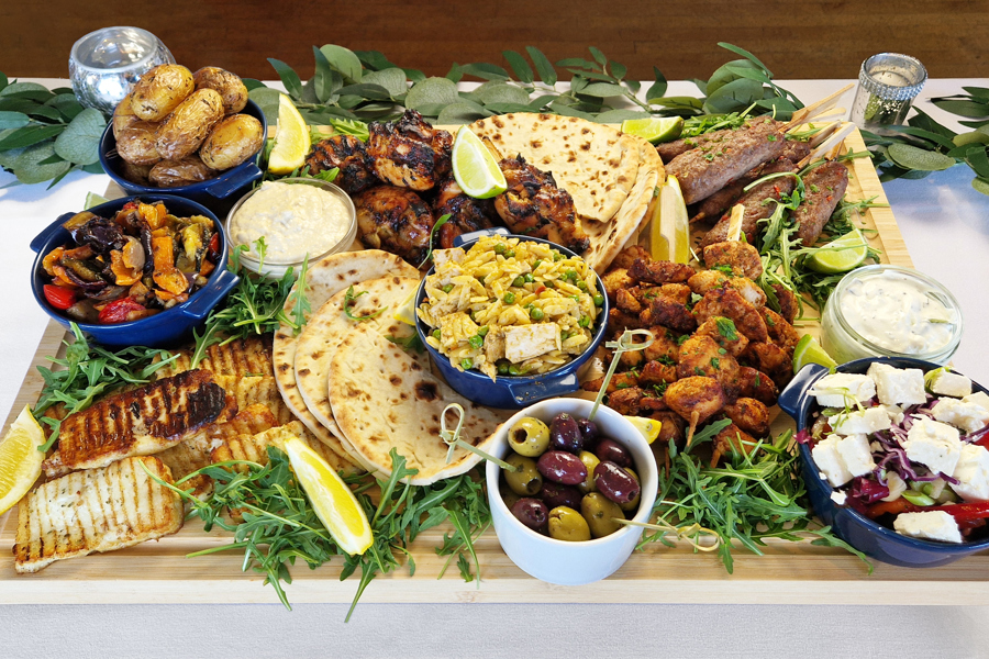 The Greek sharing board at The Manor Leeds; Chicken Souvlaki Skewers, Lamb Kofta, Grilled Halloumi, Greek-Style Chicken Thighs, Garlic & Thyme Roasted Potatoes, Flatbreads / Pittas, Roasted Vegetables, Classic Greek Salad, and Orzo Pasta Salad.