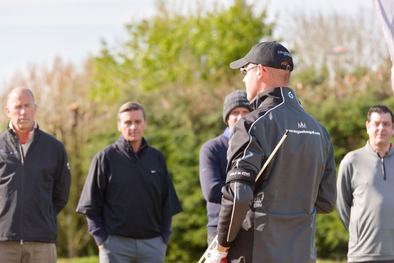 PGA Professional Mark McGeehan addressing a group of golfers.