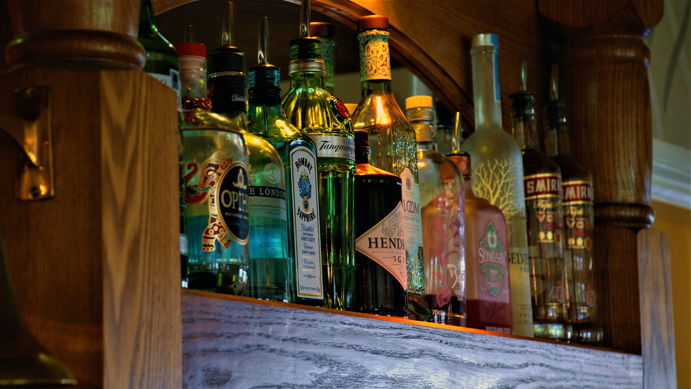 Bottle of spirits on a shelf behind the oak bar.