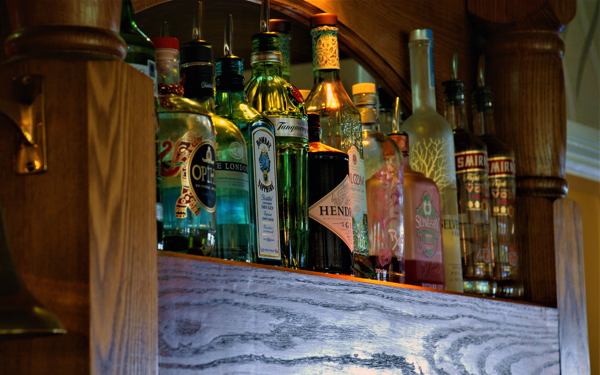 Bottle of spirits on a shelf behind the oak bar.
