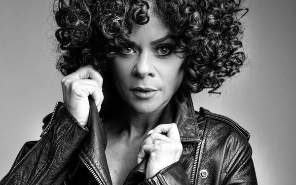 A black and white photo of Whitney Houston tribute Marcia Lynette in a leather jacket.