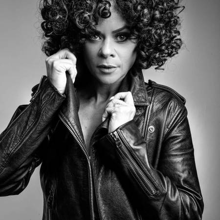 A black and white photo of Whitney Houston tribute Marcia Lynette in a leather jacket.