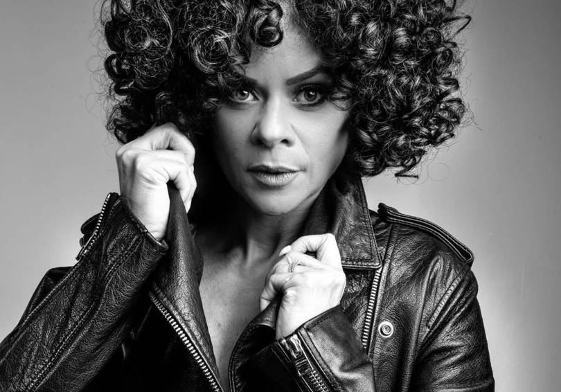 A black and white photo of Whitney Houston tribute Marcia Lynette in a leather jacket.