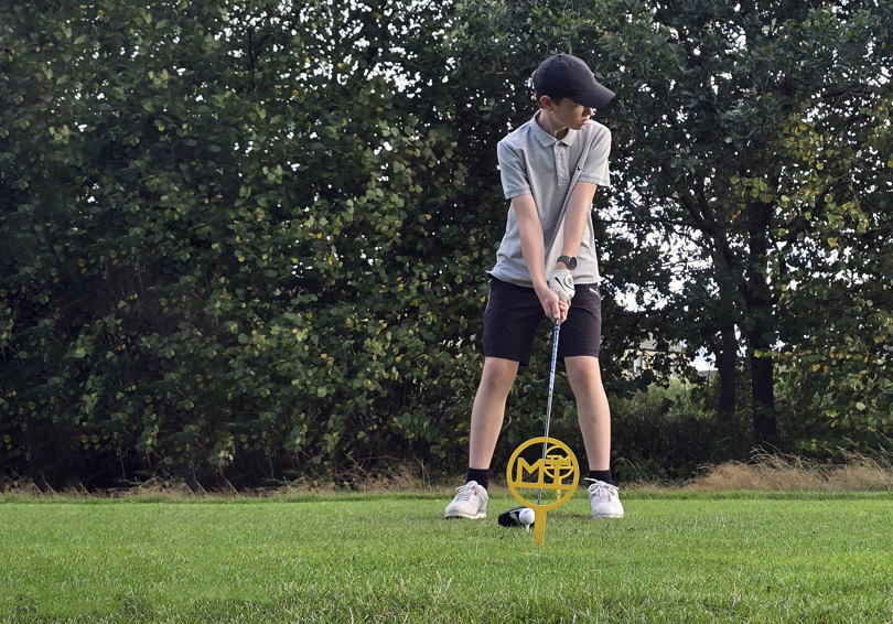A junior golfer preparing to tee off from the 6th at The Manor Leeds.