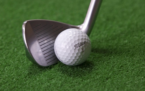 A golf ball and club.