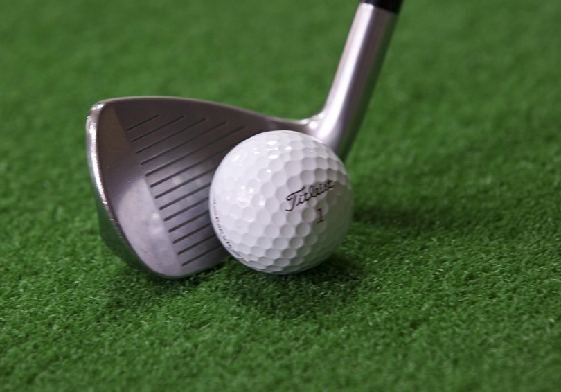 A golf ball and club.